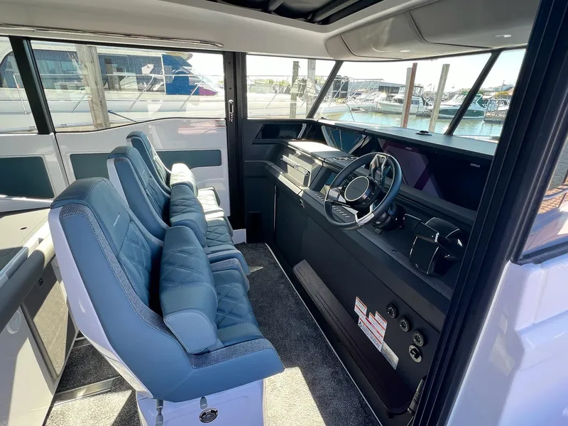 Slide: The Image of 2024 Axopar 45 XC Cross Cabin interior with modern helm and seating. - 8