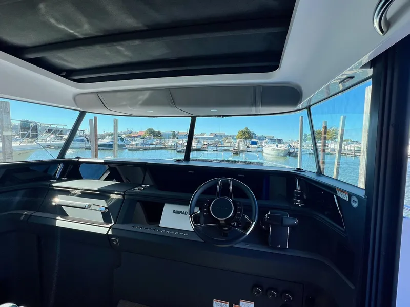 Slide: The Image of Interior view of 2024 Axopar 45 XC Cross Cabin boat at marina. - 9