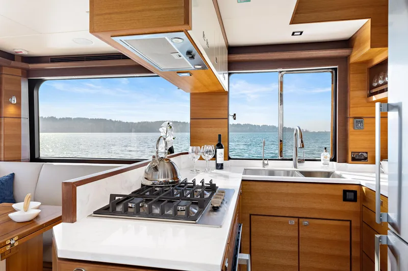 Slide: The Image of Luxurious kitchen interior of 2025 North Pacific 450 Pilothouse yacht with ocean view. - 10