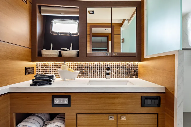 Slide: The Image of Luxurious bathroom in 2025 North Pacific 450 Pilothouse yacht with modern fixtures and wood accents. - 16
