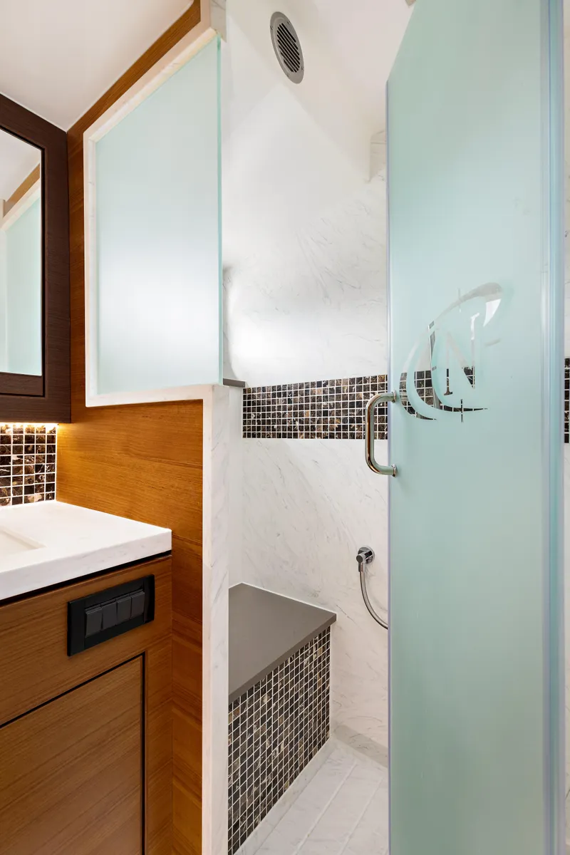 Slide: The Image of Modern bathroom in 2025 North Pacific 450 Pilothouse yacht with frosted glass shower. - 17