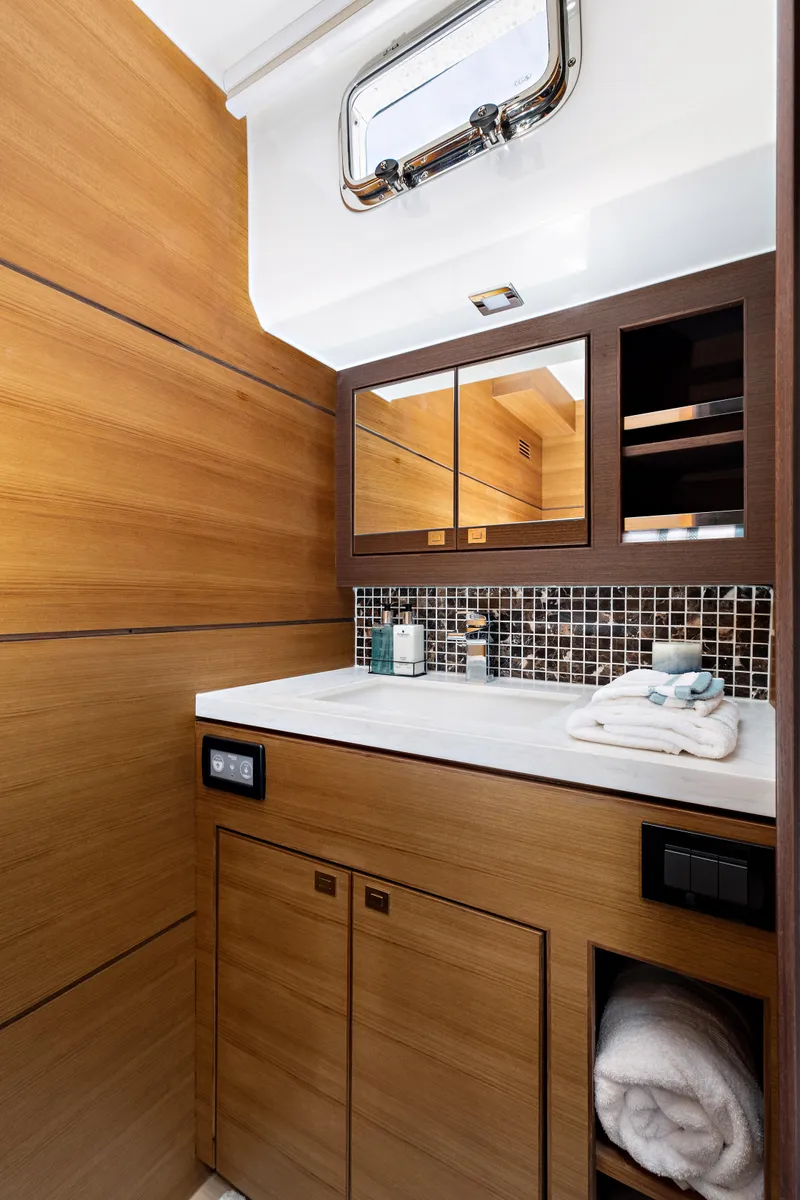 Slide: The Image of Luxurious bathroom in 2025 North Pacific 450 Pilothouse yacht with modern wood finish. - 18