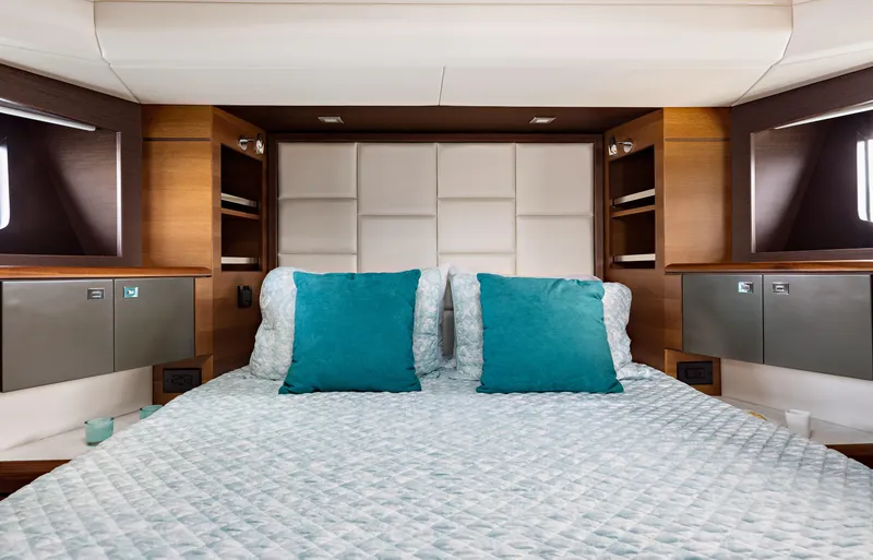 Slide: The Image of Luxurious bedroom interior of 2025 North Pacific 450 Pilothouse yacht with teal accents. - 21