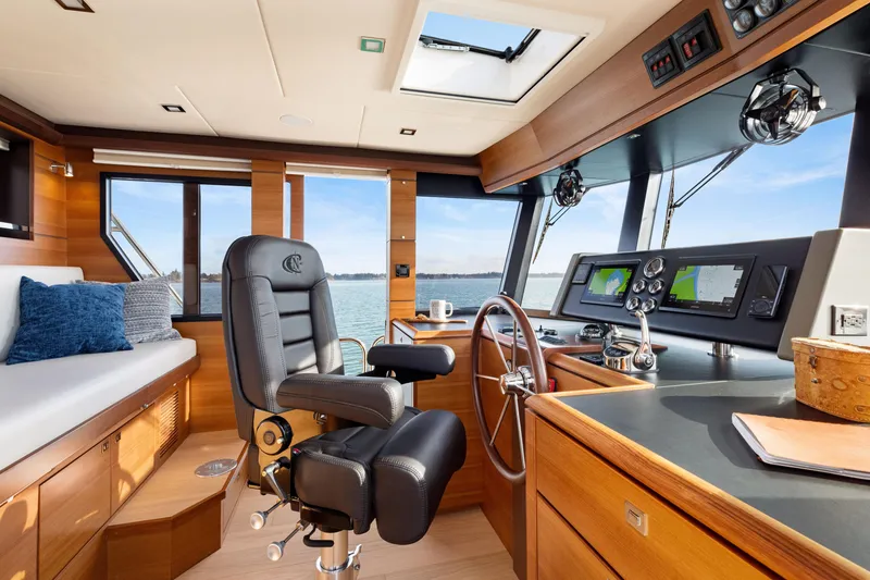 Slide: The Image of Pilothouse interior of 2025 North Pacific 450, featuring modern navigation equipment and luxurious seating. - 25