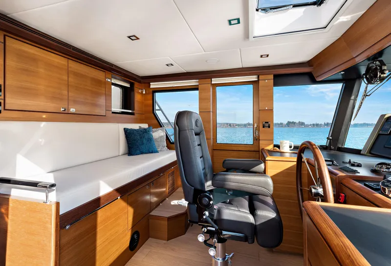 Slide: The Image of Interior of 2025 North Pacific 450 Pilothouse with luxurious seating and panoramic windows. - 27
