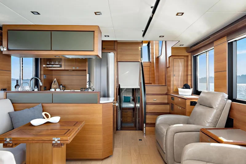 Slide: The Image of Luxurious interior of 2025 North Pacific 450 Pilothouse yacht with modern wood finishes. - 7