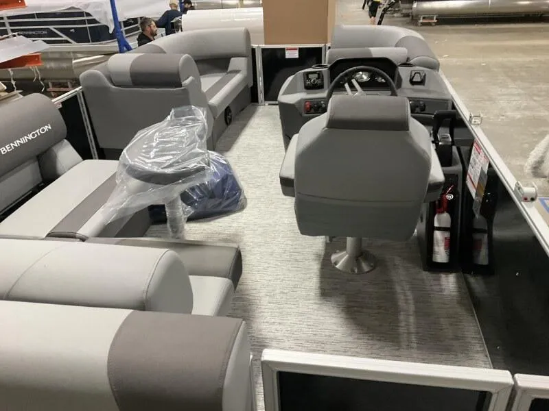 Slide: The Image of Interior of 2026 Bennington 188 SLJ pontoon boat, featuring gray seating and helm. - 28