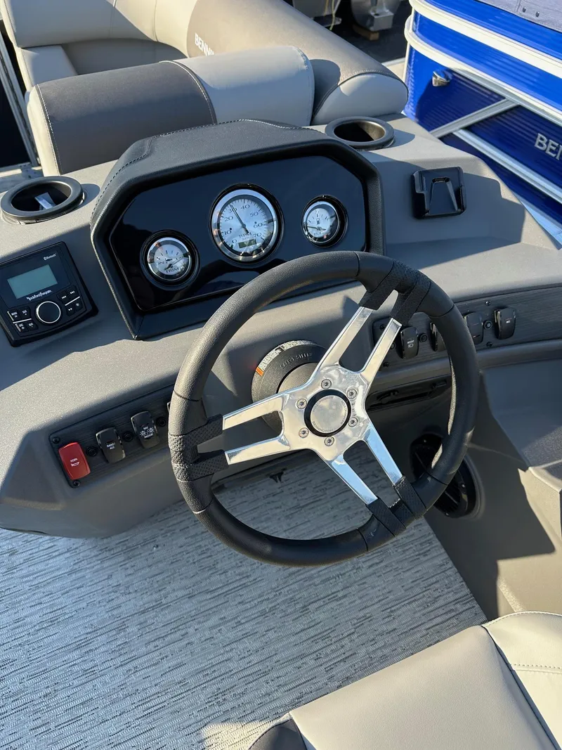 Slide: The Image of Steering console of 2026 Bennington 188 SLJ boat, featuring gauges and controls. - 14