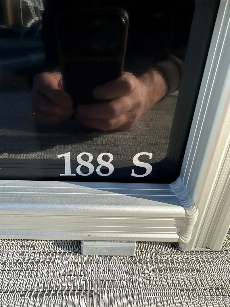 Slide: The Image of Close-up of Bennington 188 SLJ boat window with reflection, model year 2026. - 32