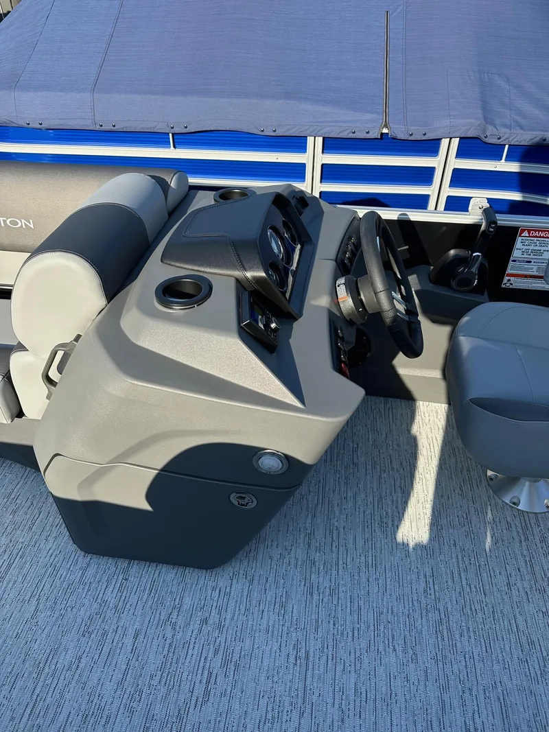 Slide: The Image of Bennington 188 SLJ boat console with steering wheel, cup holders, and seating, 2026 model. - 37