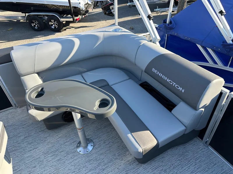 Slide: The Image of Bennington 188 SLJ 2026 boat interior with gray seating and table, on order for July. - 41