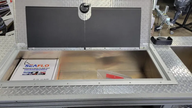 Slide: The Image of Open storage compartment on Smoker Craft Phantom 20 X2 with SEAFLO washdown pump kit. - 27