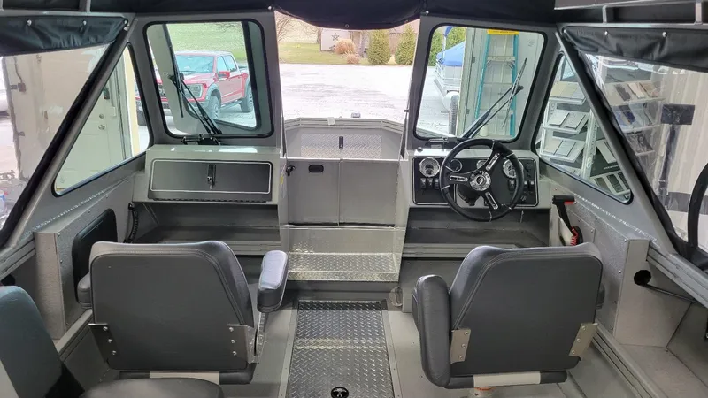 Slide: The Image of 2025 Smoker Craft Phantom 20 X2 offshore boat interior with steering wheel and seating. - 7