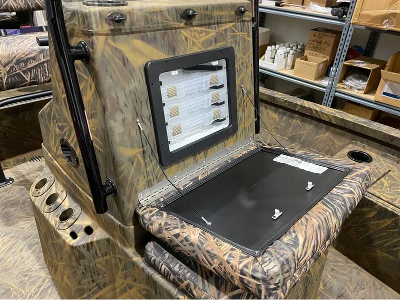 Slide: The Image of 2024 G3 Bay 20 GX boat with camo design and open storage compartment. - 16