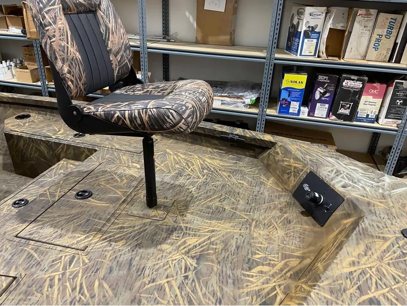 Slide: The Image of 2024 G3 Bay 20 GX boat with camo seat and deck in storage room. - 18