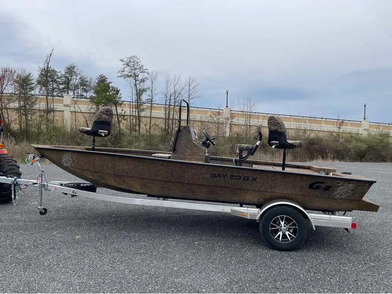 Slide: The Image of 2024 G3 Bay 20 GX boat on trailer in outdoor setting. - 19