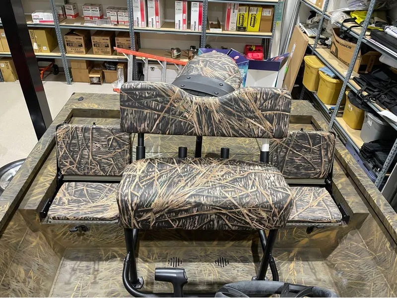 Slide: The Image of 2024 G3 Bay 20 GX boat with camo seats in storage room. - 21