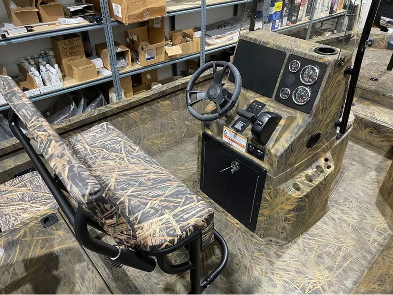 Slide: The Image of 2024 G3 Bay 20 GX boat interior with camo seats and control panel. - 22