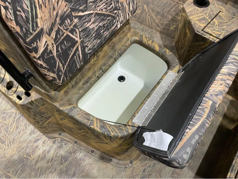 Slide: The Image of 2024 G3 Bay 20 GX boat with camo seating and storage compartment. - 23