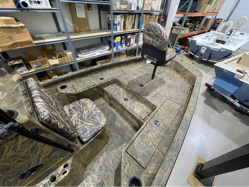 Slide: The Image of 2024 G3 Bay 20 GX boat with camo seats in a storage area. - 6