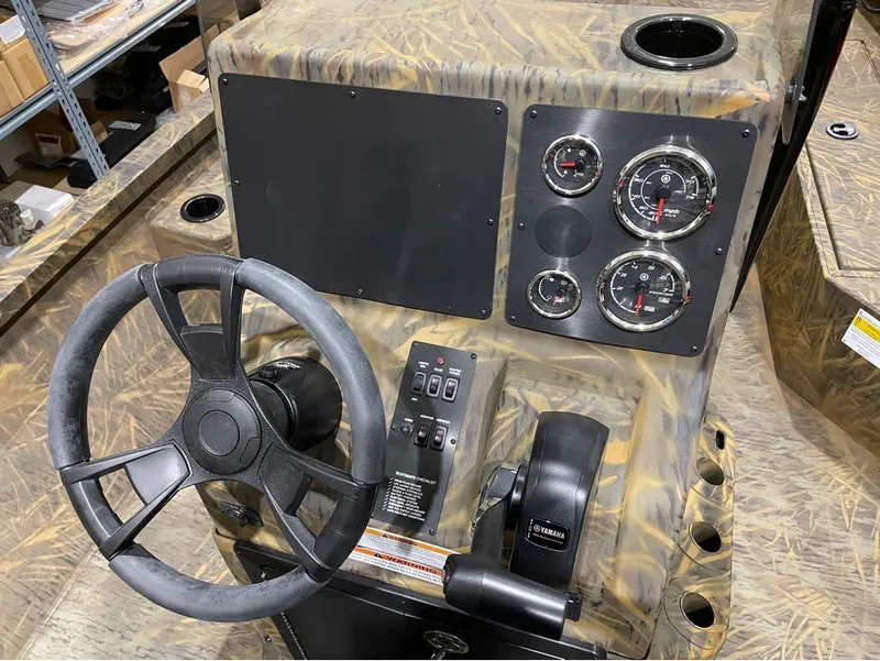 Slide: The Image of 2024 G3 Bay 20 GX boat dashboard with steering wheel and gauges. - 8