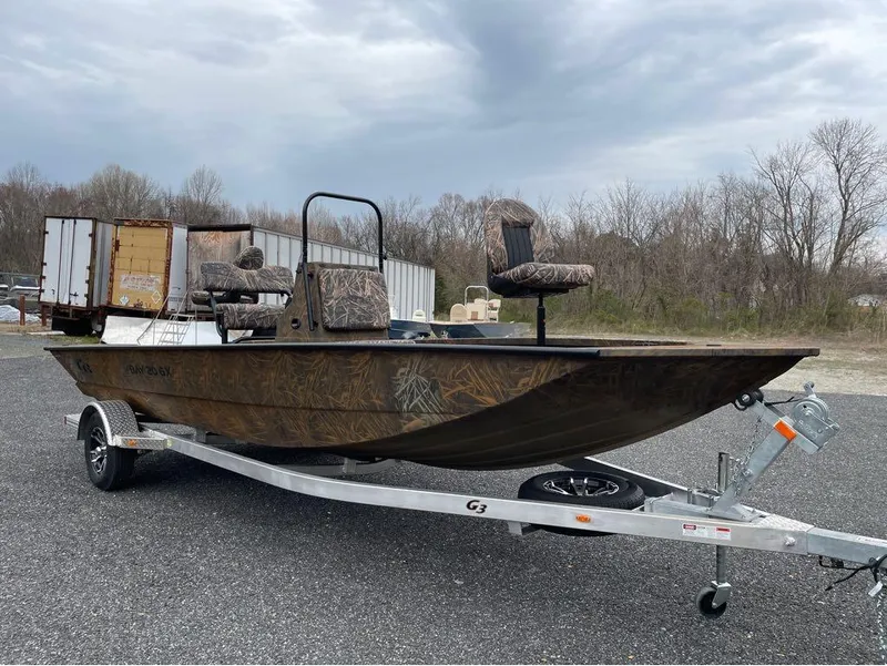 Slide: The Image of 2024 G3 Bay 20 GX boat on trailer with camo seats. - 9