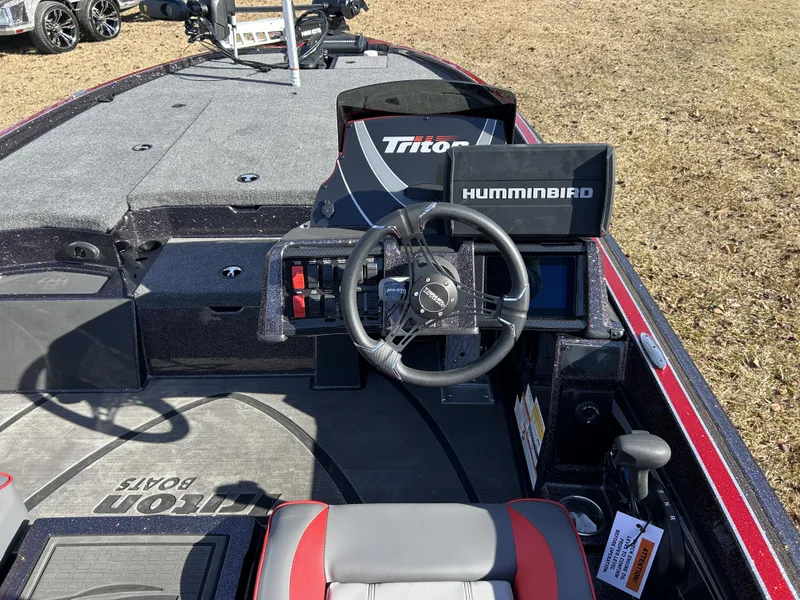Slide: The Image of 2024 Triton 20XP boat interior with steering wheel and Humminbird electronics. - 15