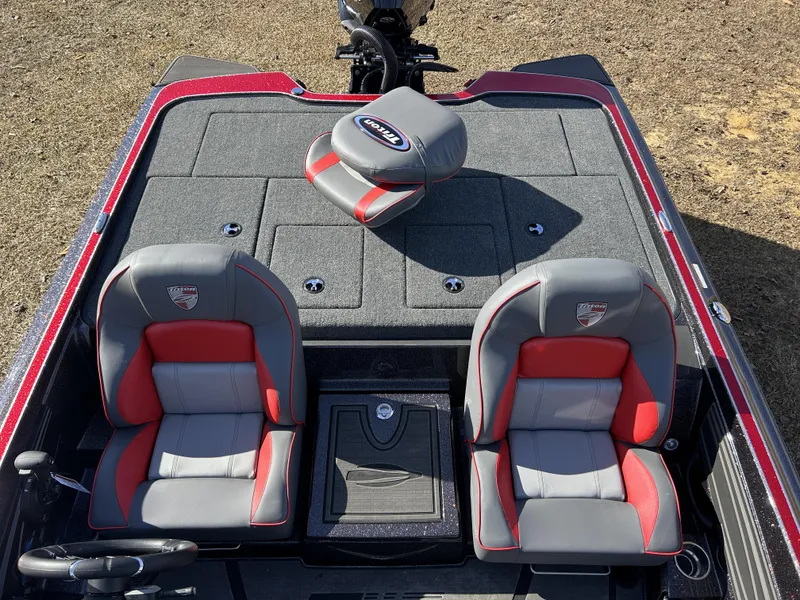 Slide: The Image of 2024 Triton 20XP boat interior with red and gray seats, steering wheel, and storage compartments. - 19