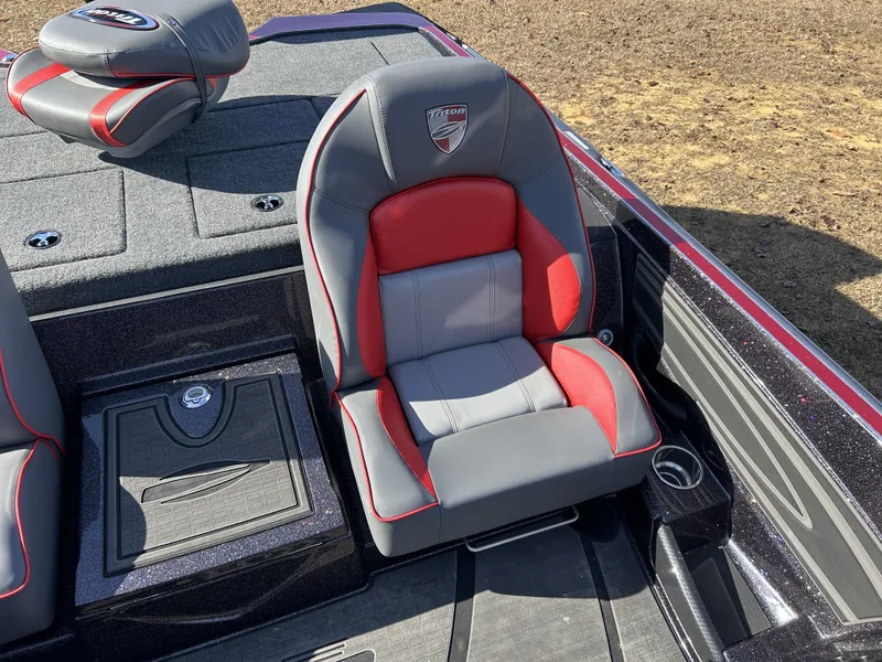 Slide: The Image of 2024 Triton 20XP boat seat with red and gray upholstery, featuring logo and storage compartment. - 20
