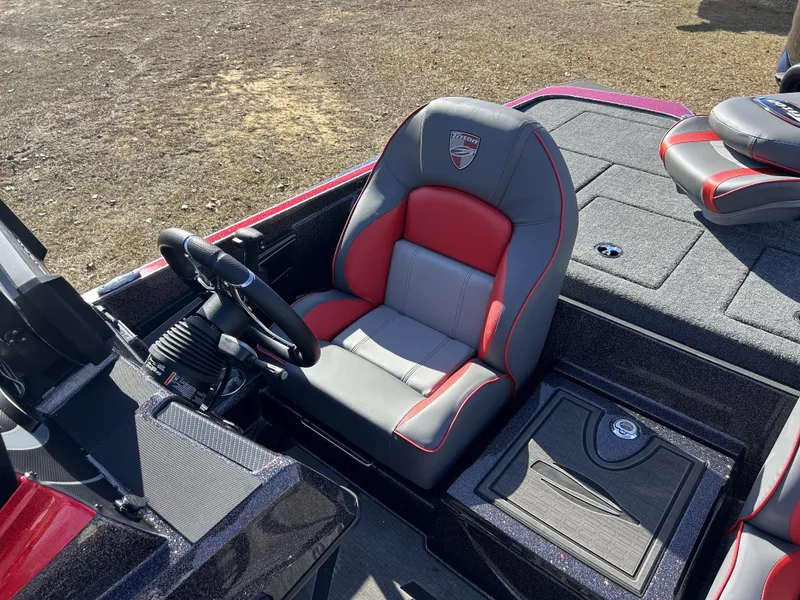 Slide: The Image of 2024 Triton 20XP boat interior with red and gray seating, steering wheel, and storage compartments. - 21
