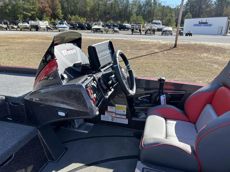 Slide: The Image of 2024 Triton 20XP boat interior with steering wheel and control panel. - 23