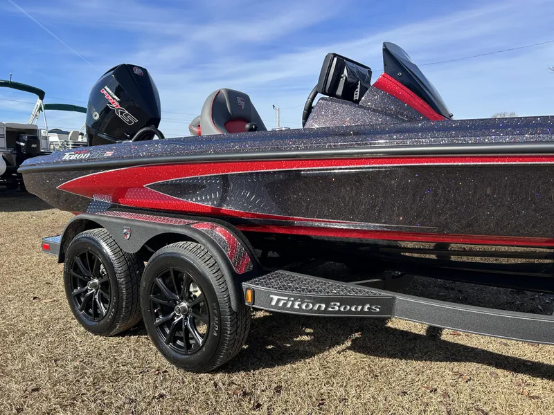 Slide: The Image of 2024 Triton 20XP boat with sleek design and dual axle trailer. - 3