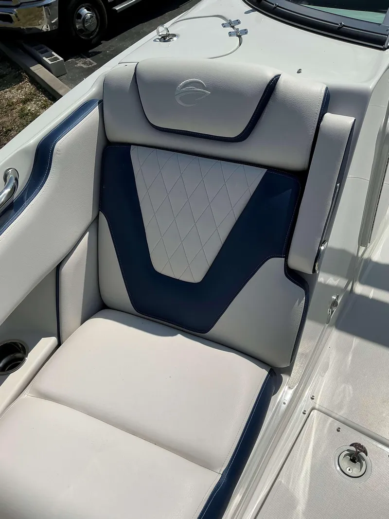 Slide: The Image of 2024 Crownline 270 XSS boat seat with white and navy upholstery. - 5