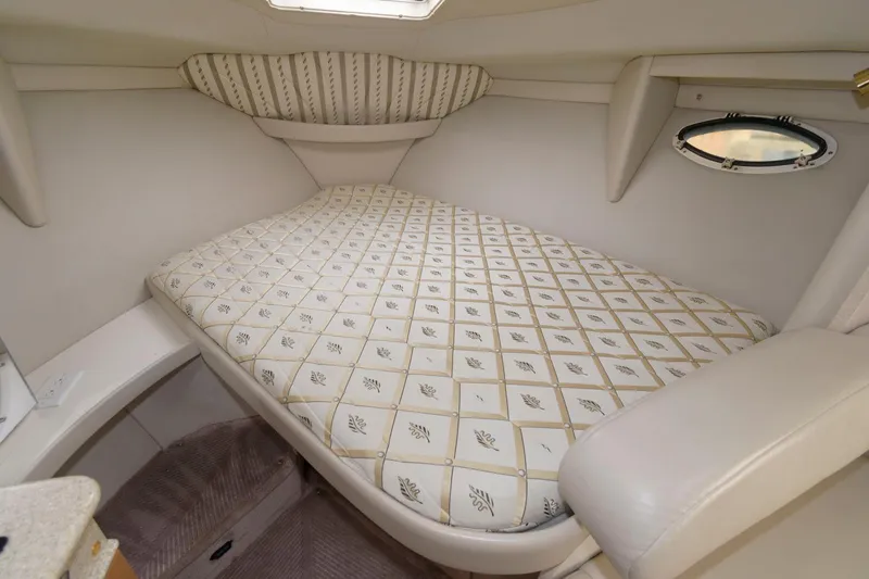 Slide: The Image of 2002 Formula 31 PC cabin with a comfortable bed and porthole window. - 10