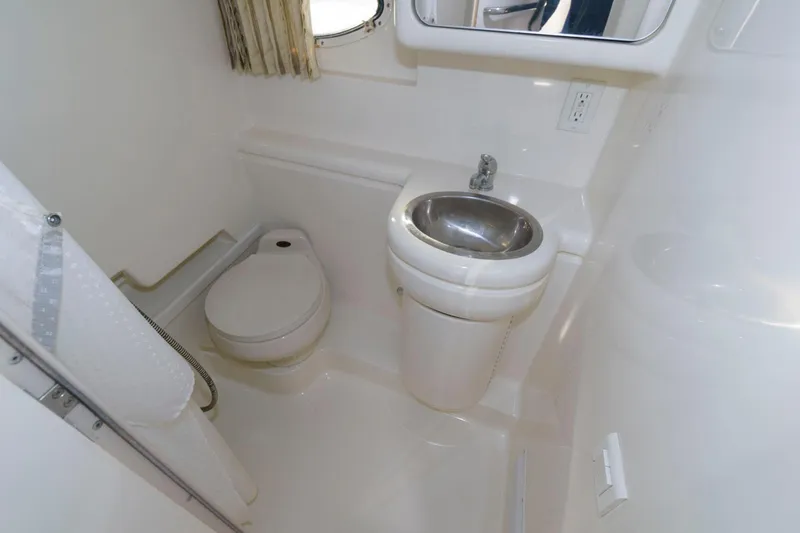 Slide: The Image of 2002 Formula 31 PC boat bathroom with toilet, sink, and shower. - 12