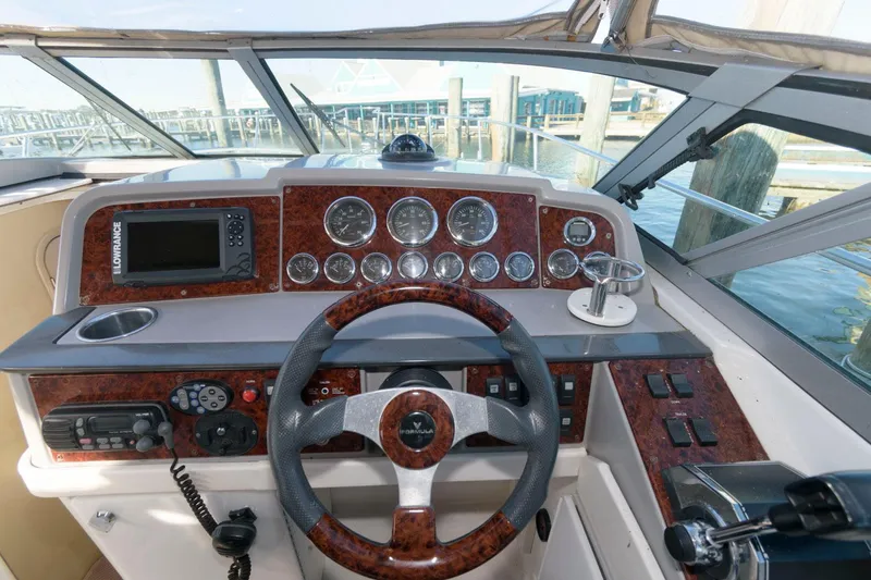 Slide: The Image of 2002 Formula 31 PC boat dashboard with steering wheel and navigation instruments. - 4