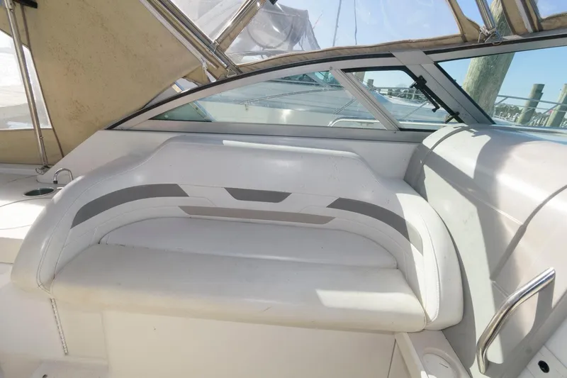 Slide: The Image of 2002 Formula 31 PC boat interior seating area with white and gray upholstery. - 5