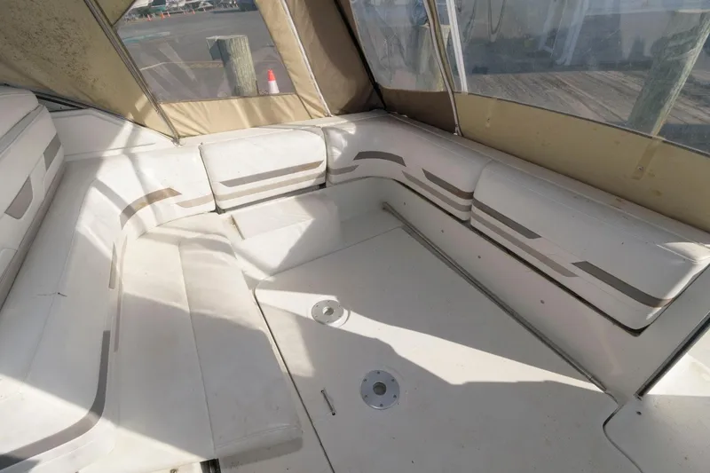 Slide: The Image of 2002 Formula 31 PC boat interior with white seating and beige accents. - 6