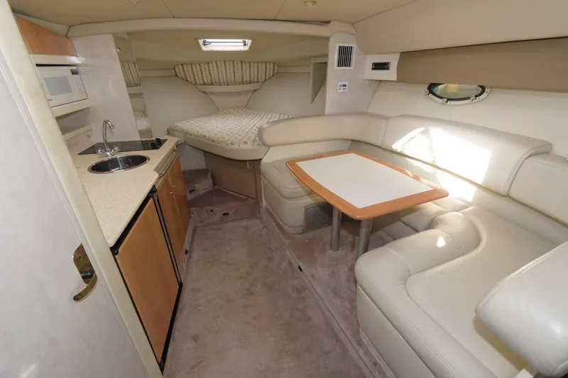 Slide: The Image of 2002 Formula 31 PC cabin interior with kitchenette, dining area, and bed. - 7
