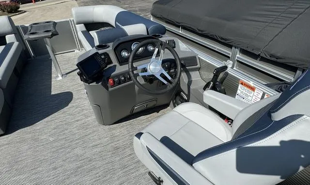Slide: The Image of 2024 Bennington 22 SSR pontoon boat with cover in a warehouse. - 14