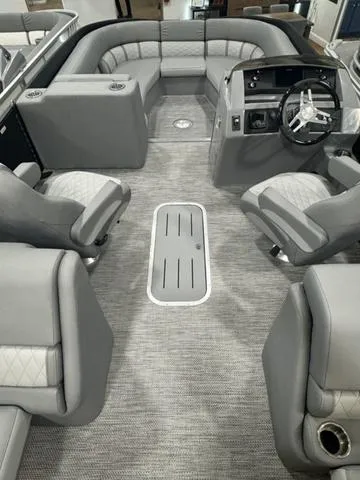 Slide: The Image of 2024 Bennington 25 LTFB pontoon boat interior view in a warehouse. - 16