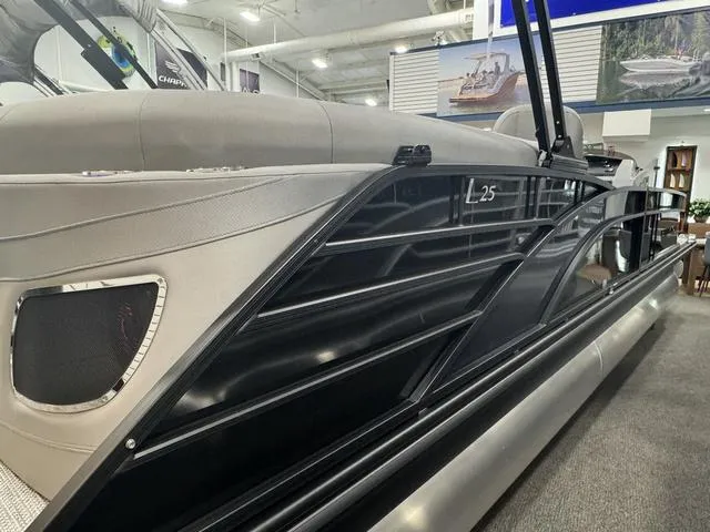 Slide: The Image of 2024 Bennington 25 LTFB boat interior with luxurious gray seating and carpeted flooring. - 5