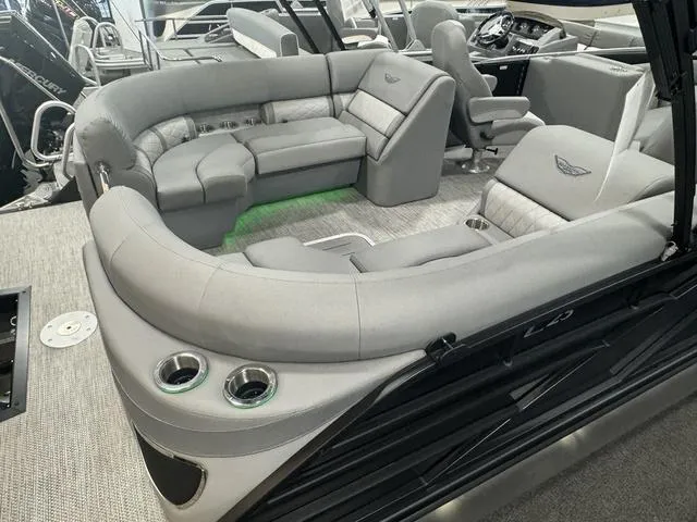 Slide: The Image of 2024 Bennington 25 LTFB boat dashboard with steering wheel and control panel. - 6