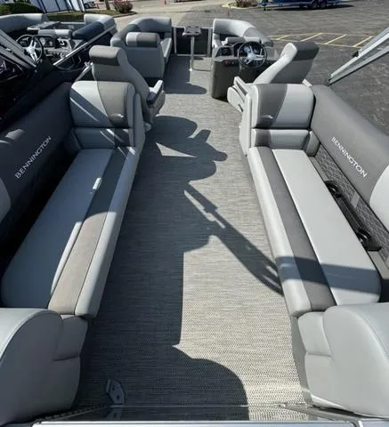 Slide: The Image of 2024 Bennington 22 SSR pontoon boat in a showroom with a boarding ladder. - 11