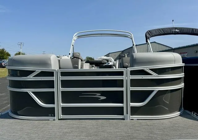 Slide: The Image of 2024 Bennington 22 SSR pontoon boat in a warehouse, partially wrapped in bubble wrap. - 2