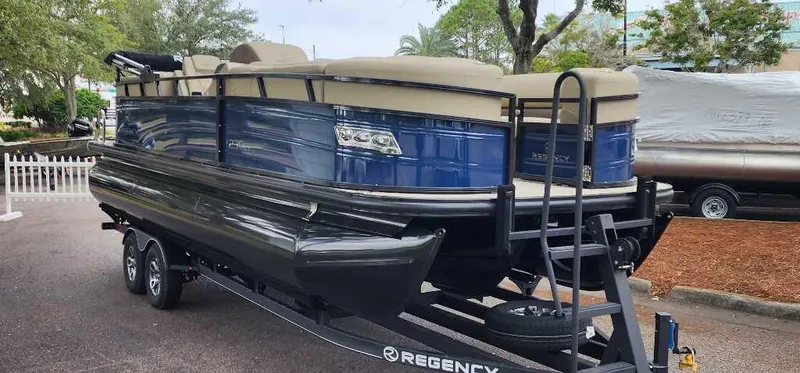 Slide: The Image of 2024 Regency 230 LE3 pontoon boat on a trailer. - 1