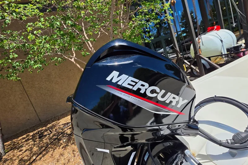 Slide: The Image of Mercury outboard motor on 2024 Mako Pro Skiff 13 CC, parked outdoors. - 7