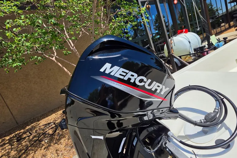 Slide: The Image of Mercury outboard motor on 2024 Mako Pro Skiff 13 CC boat, outdoor setting. - 6