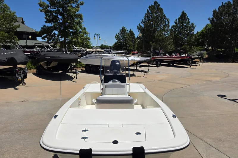 Slide: The Image of 2024 Mako Pro Skiff 13 CC boat displayed outdoors with other boats in the background. - 3