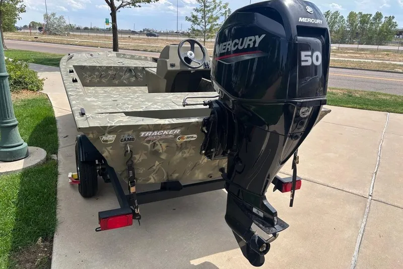 Slide: The Image of 2024 Tracker Grizzly 1648 SC boat with Mercury 50 outboard motor on a trailer. - 11